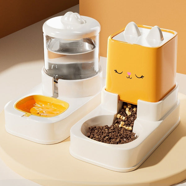 Pet feeding and water station with a yellow cat-shaped dispenser on a beige surface.