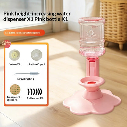 Pink automatic cat water dispenser with a clear bottle, shown on a wooden floor with an inset product kit list. The kit includes a pink dispenser, a clear bottle, a Velcro hook, a suction cup, a cleaning brush, a straw, and transparent stickers.