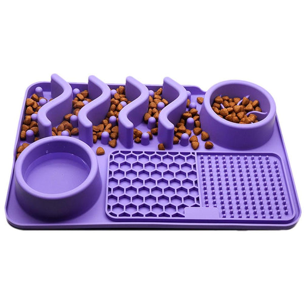 Purple pet feeding mat with two bowls and raised sections filled with dog food on a white background