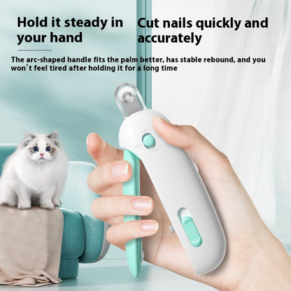 Pet nail trimmer being held by a hand with a cat in the background, on a light blue surface.