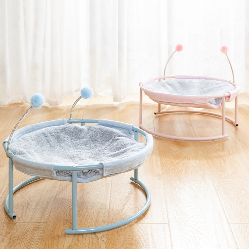 Two pet beds with stand-like structures on a wooden floor.