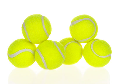 Stack of yellow tennis balls with white strings on a white background