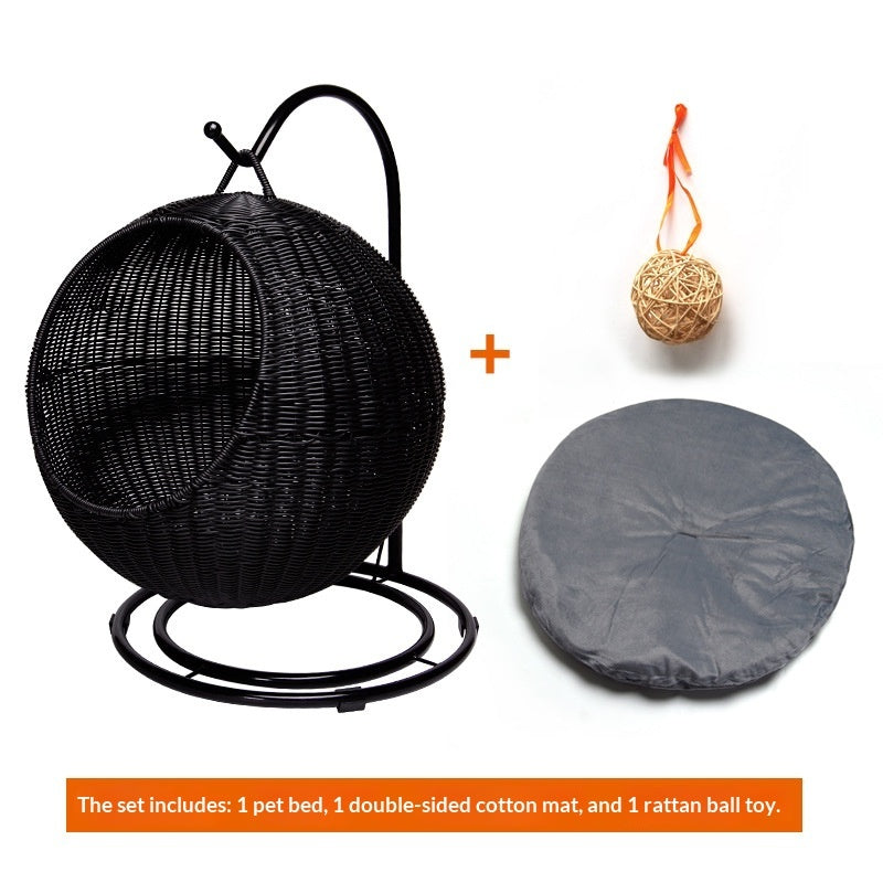 Black woven pet bed with a gray cover and rattan ball toy on a white background
