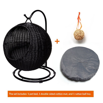 Black woven pet bed with a gray cover and rattan ball toy on a white background