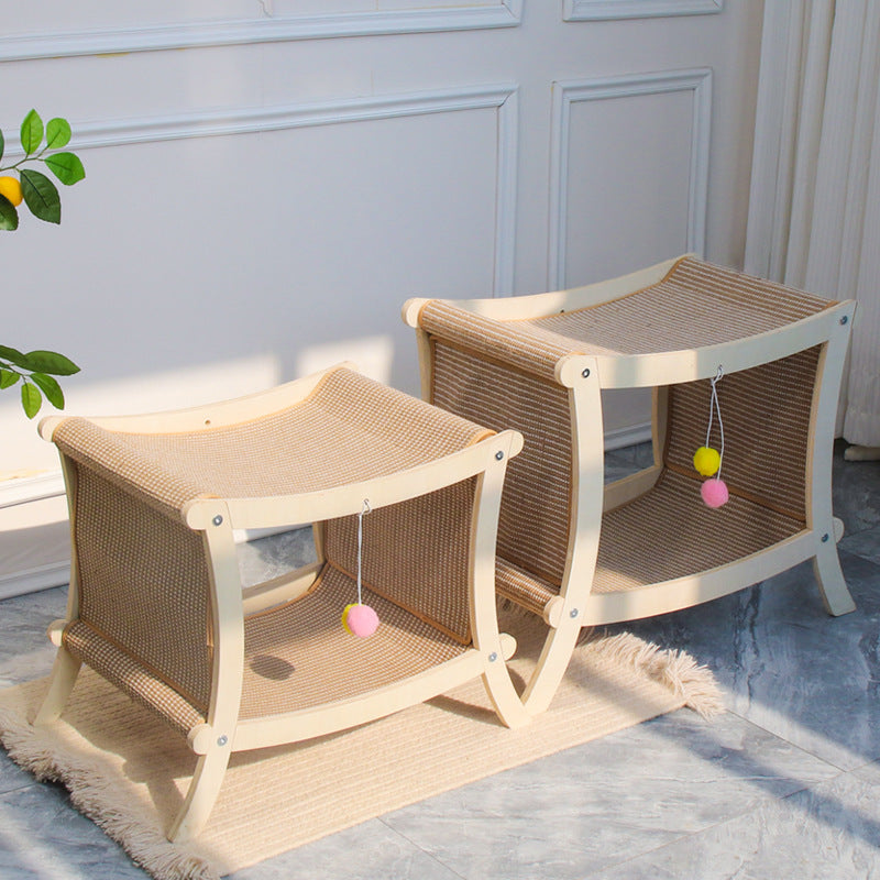 Two cat beds with a scratching post on a light blue floor.