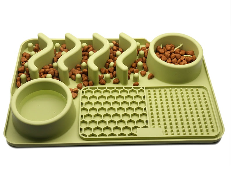 Green puzzle feeder with two bowls and food on a white background