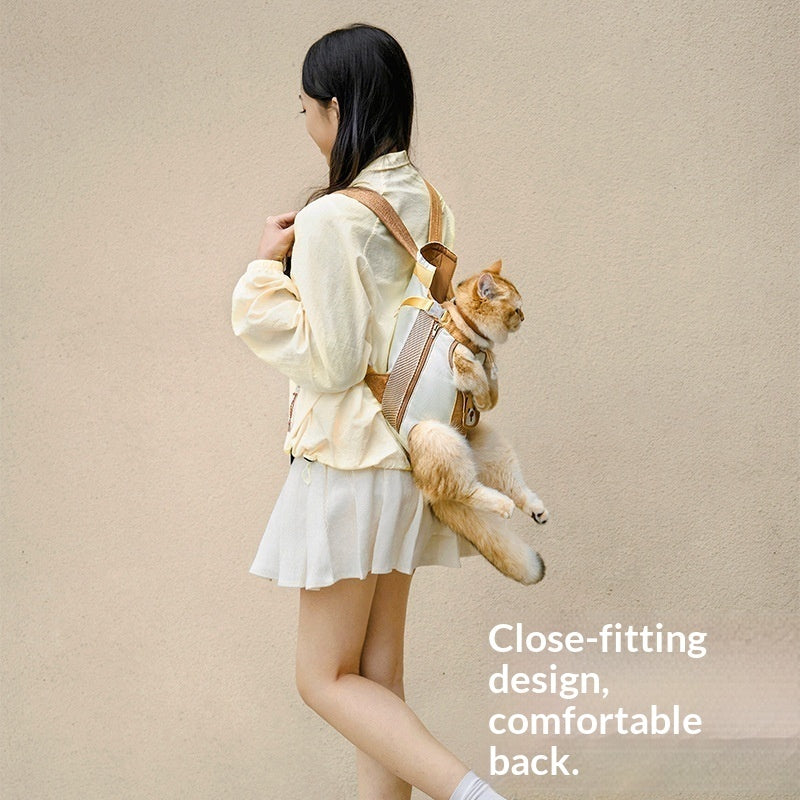 Woman wearing a beige jacket with a cat in a backpack against a beige background