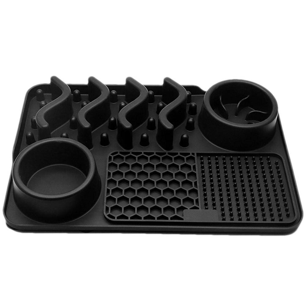 Black silicone mat with cup holders and textured surface on a white background