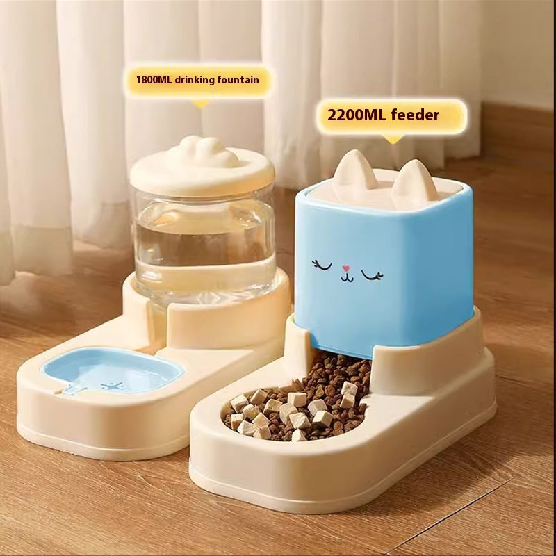 Pet drinking fountain and feeder set on a wooden floor with curtains in the background.