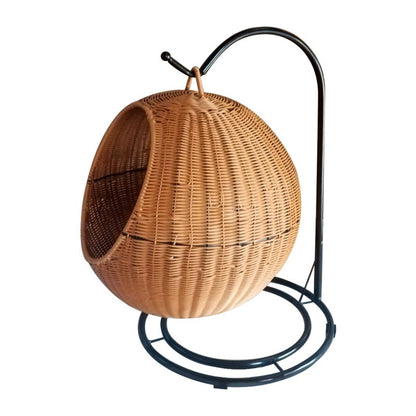 Wicker egg-shaped chair on a metal stand against a white background