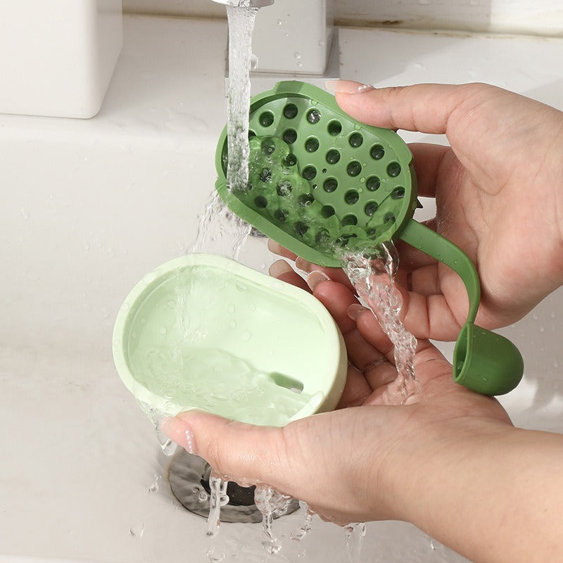 Green kitchen tool with a mesh design being rinsed under running water.