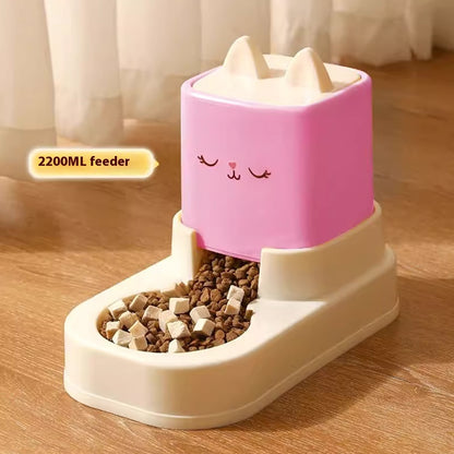 Pink and white pet feeder with cartoon face on a wooden floor