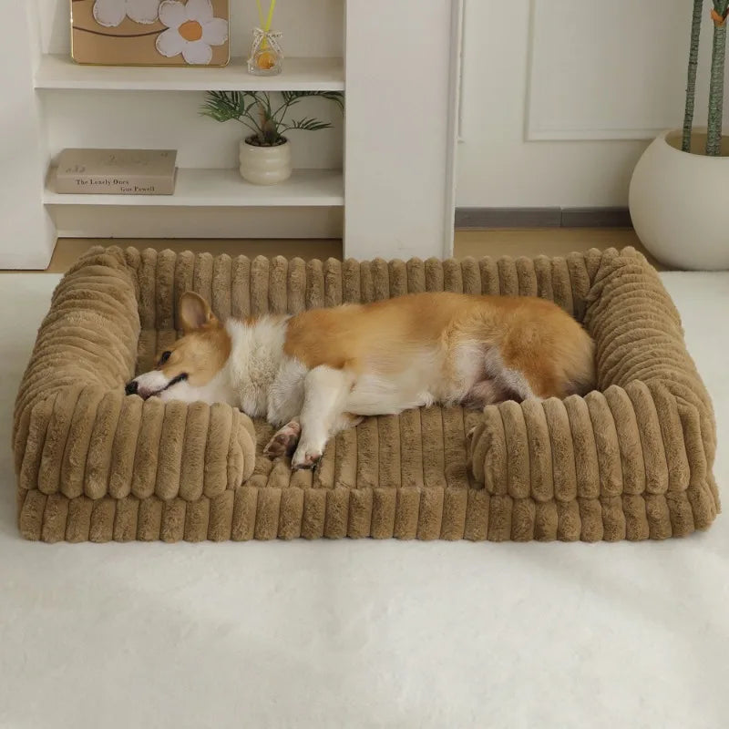 Two dogs lying on a plush brown pet bed in a home setting.