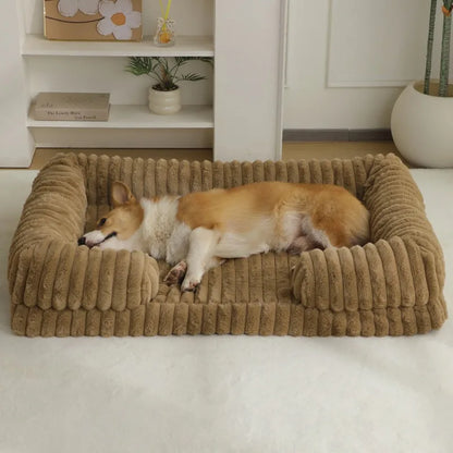 Two dogs lying on a plush brown pet bed in a home setting.