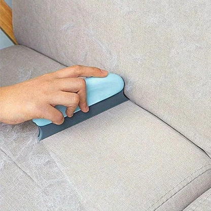 Hand using a blue and gray tool on a beige sofa
