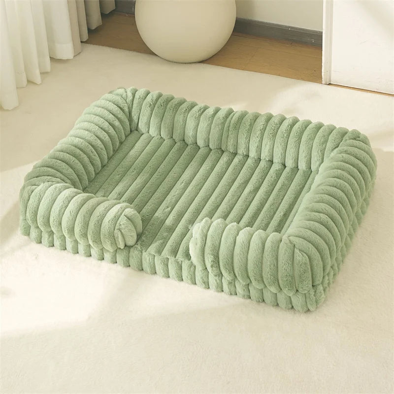 Green pet bed on a white surface with a neutral background