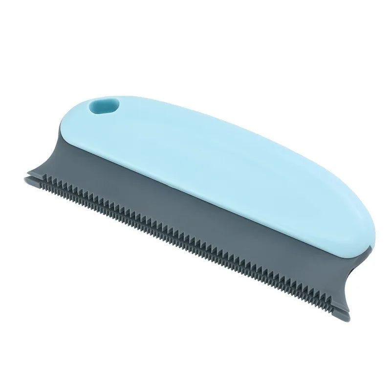 Blue pet grooming brush with black bristles on a white background