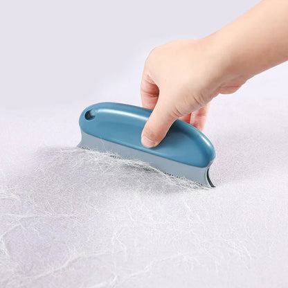 Hand using a blue silicone squeegee on a white surface