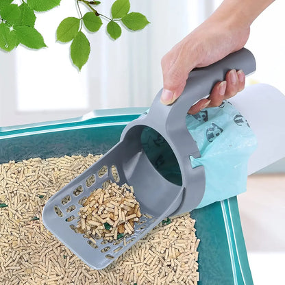 Person using a gray cat litter scoop to collect cat litter from a litter box.