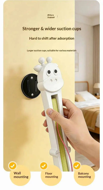 Hand holding a white tool with cartoon design against a beige wall, with text about suction cup features.