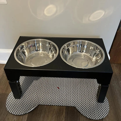 Adjustable elevated dog feeder with double bowls placed on pet feeding mat