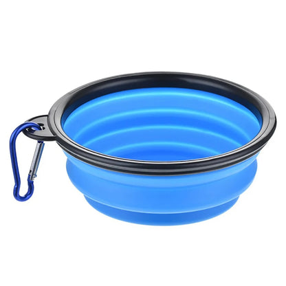 Blue collapsible dog bowl with black rim and carabiner on a white background