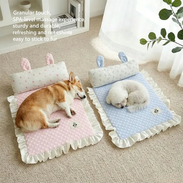 Two pet massage mats with bunny ears on a beige carpet, one pink and one blue, each shown with a sleeping dog. Text on the left describes the granular touch, SPA-level massage, sturdy and durable construction, and ability to stick to fur.