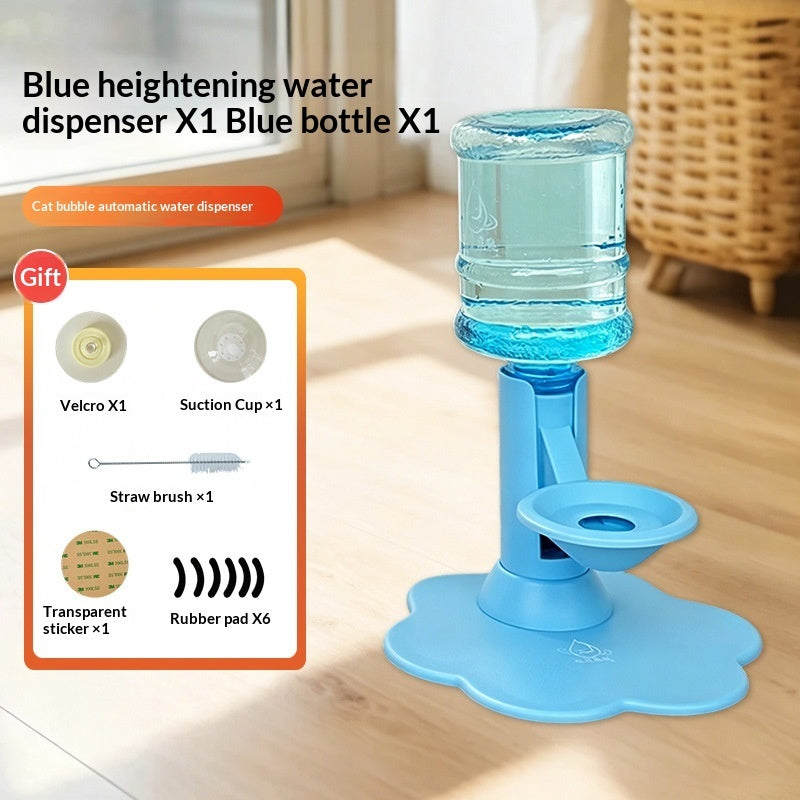 A blue automatic water dispenser bottle stand with a flower-shaped base, shown on a wooden floor in a room setting. The image includes a product inset showing included accessories like a velcro, suction cup, straw brush, and transparent sticker.