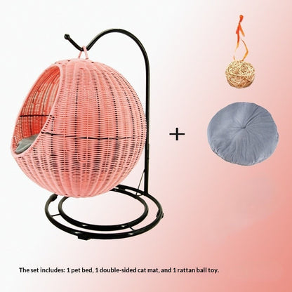 Pink woven pet bed with stand, double-sided cat mat, and rattan ball toy on a gradient background.
