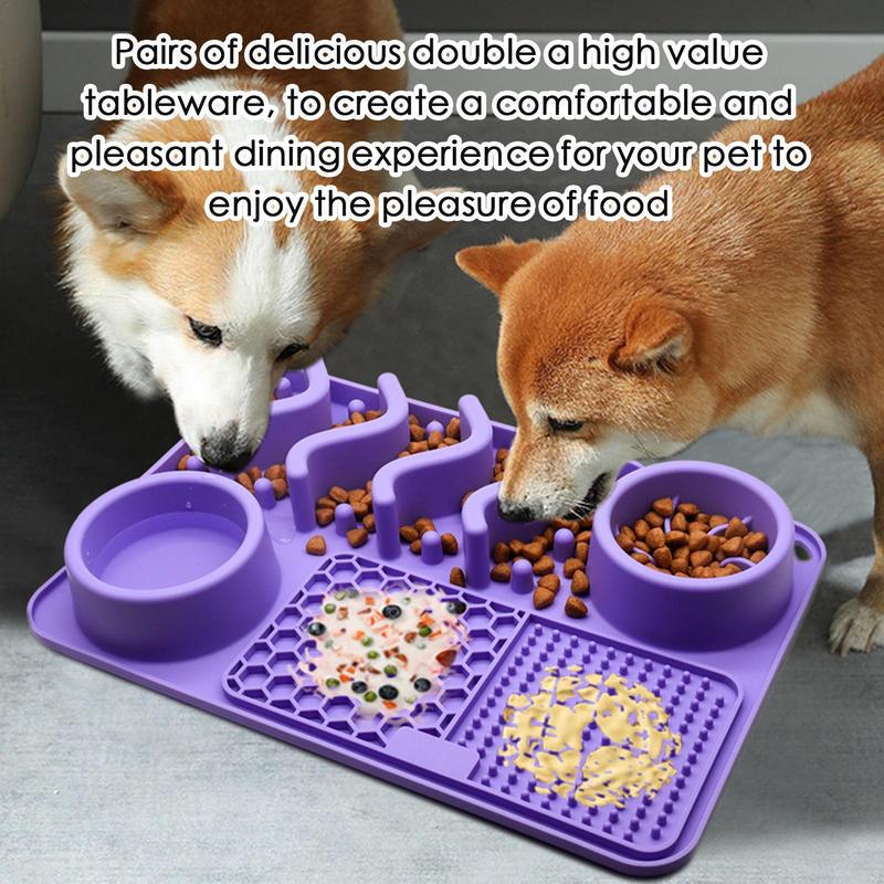 Two dogs eating from a purple pet feeding mat with multiple compartments.