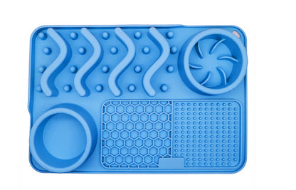 Blue silicone mat with various textured sections on a white background