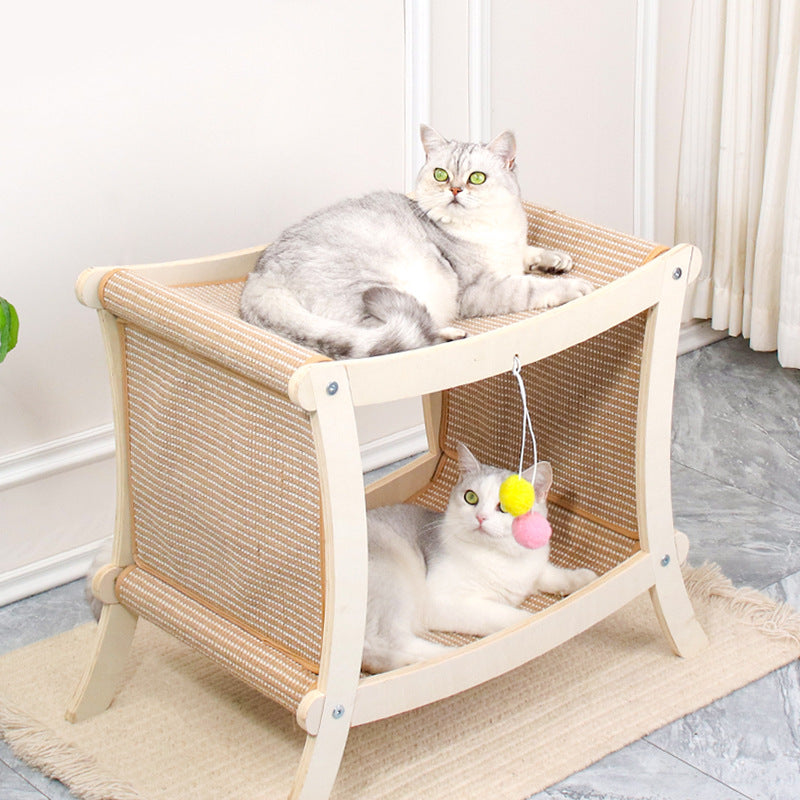 Two cats on a wooden cat shelf with toys in a room.